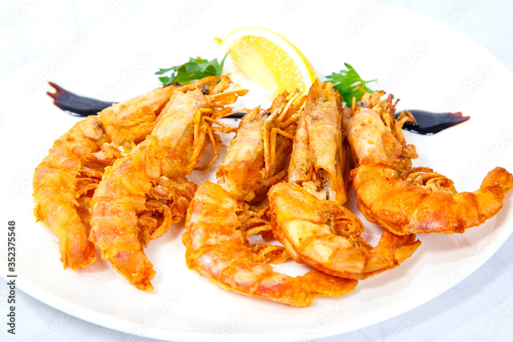 Langoustines on the grill. Plate on a white background Langoustines on the grill. Plate on a white background
