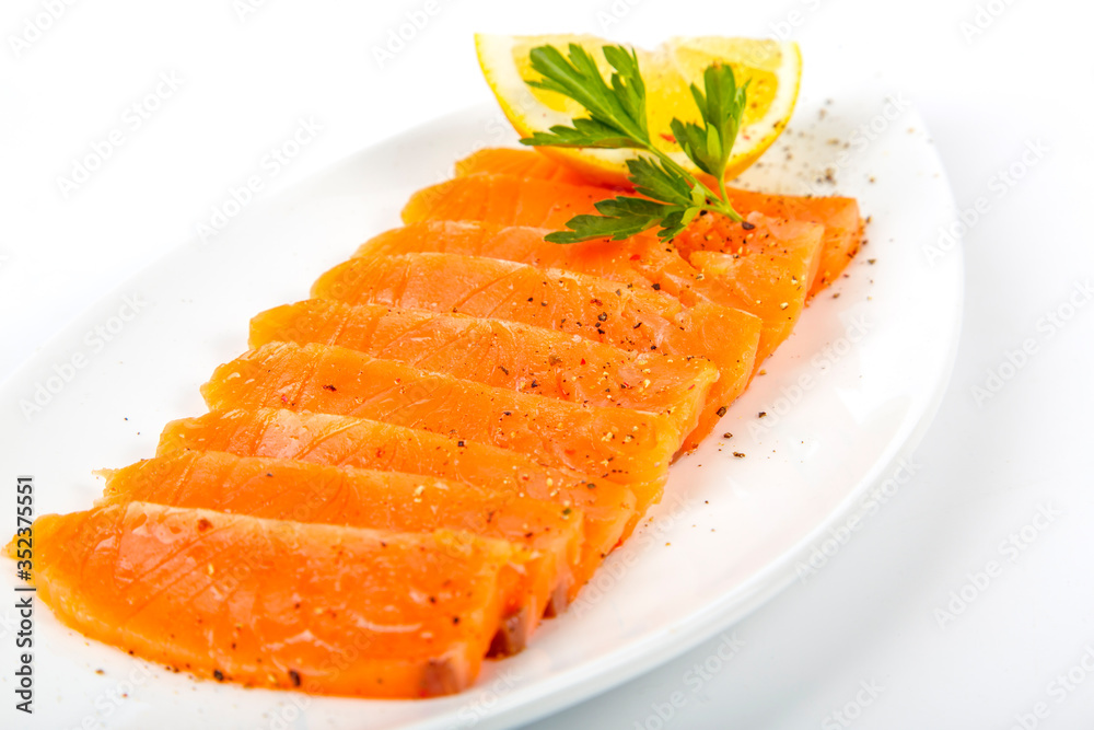 Salted salmon with butter and lemon. Plate on a white background Salted salmon with butter and lemon. Plate on a white background