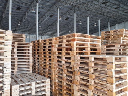 Wooden pallets stacked in stock at warehouse storage