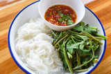 Thai food top view rice noodles with chilli sauce spicy served on plate - Rice vermicelli and vegetable Asian style food