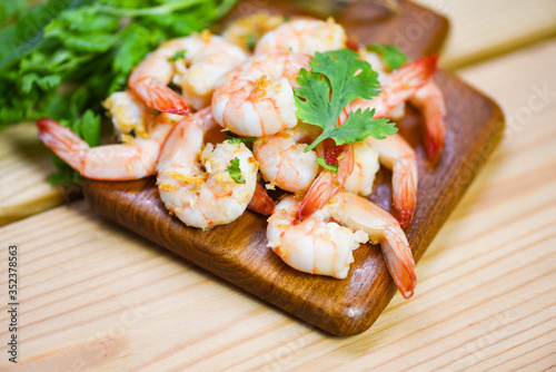 Shrimp delicious seasoning spices on wooden cutting board background - cooked shrimps or prawns , Seafood shelfish