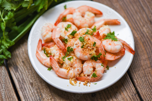 Shrimp delicious seasoning spices on white plate and wooden background - cooked shrimps or prawns , Seafood shelfish