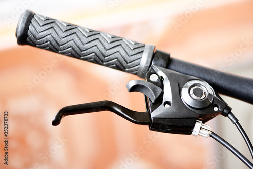 Konstfotografi Bicycle handlebars and bike hand pushing brake lever /