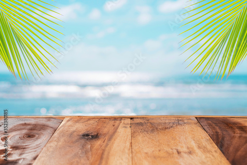 Fototapeta Naklejka Na Ścianę i Meble -  Selective focus of old wood table with beautiful beach background for display your product.