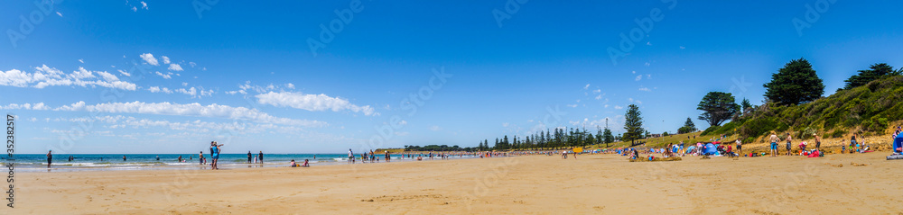 Panorama of wide, sandy Front Beach, with Point Danger in the distance, Torquay, Surf Coast Shire, Great Ocean Road, Victoria, Australia