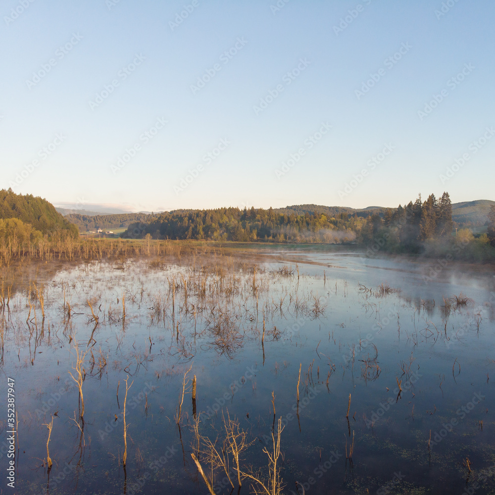 Morning lake with steam at sunrise, morning landscape. Shot from a height Morning lake with steam at sunrise, morning landscape. Shot from a height
