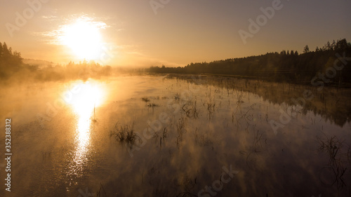 Dawn on the lake  filmed from a height  steam over water. Landscape in the forest