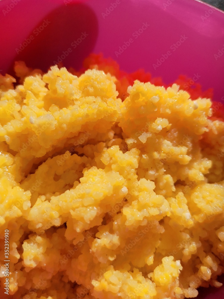Close-up of corn porridge in a plastic pink plate