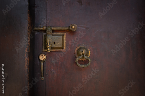Old black wooden door with gold antique handle. Details Classic vintage doors of the interior element. © sirintra