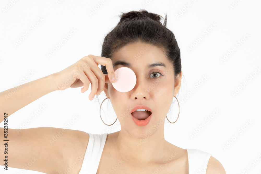 Pretty beauty young Asian woman covering her eyes with cotton pad over white isolated background. Healthy skin and cosmetics concept. Pretty beauty young Asian woman covering her eyes with cotton pad over white isolated background. Healthy skin and cosmetics concept.