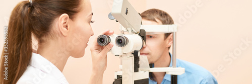 ophthalmologist doctor in exam optician laboratory with male patient. Men eye care medical diagnostic. Eyelid treatment.