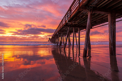 Dramatic, colorful sunset over a wooden beach pier. Imperial Beach, California, United states of America