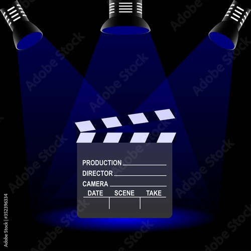 Clapperboard used in filmmaking with text and three spotlights photo