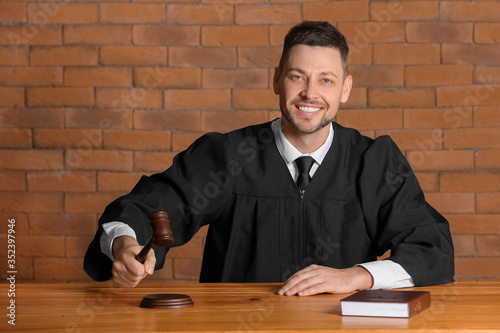 Male judge at table in cour...