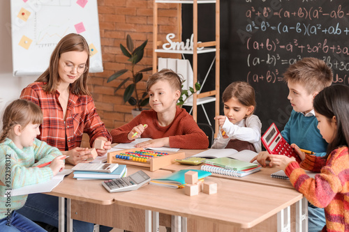 Children with math teacher ...