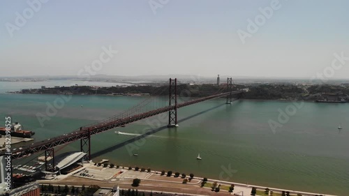 Wallpaper Mural Aerial 4K Drone Footage of Tejo River and Red Bridge Twenty-Fifth of April (Ponte Vinte e Cinco de Abril), in Lisbon, Portugal. Christ the King Monument in Almada. Cars crossing the Bridge. Torontodigital.ca
