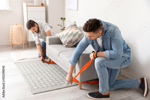 Men using cargo belts for c...