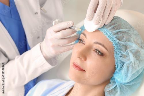 Woman receiving filler inje...