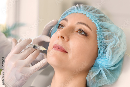 Woman receiving filler inje...