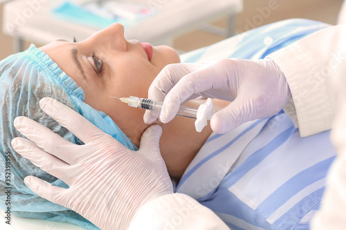 Woman receiving filler inje...