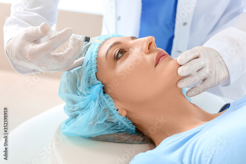 Woman receiving filler inje...