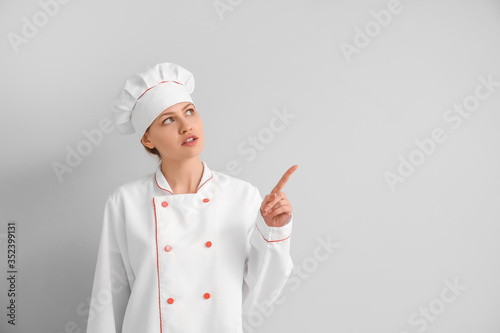 Beautiful female chef point...