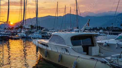 Parking yachts in the port against the backdrop of the sea sunset