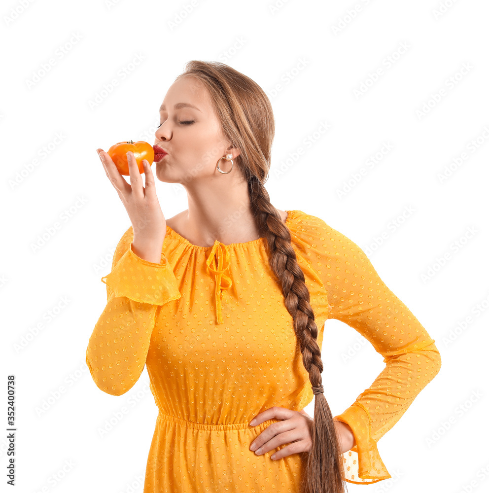 Young woman with tomato on white background. Diet concept Young woman with tomato on white background. Diet concept