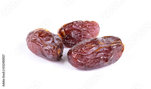 Medjool dried date palm fruits isolated on a white background.