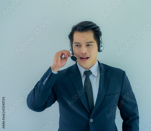 Portrait of happy smiling male customer support phone operator at workplace.