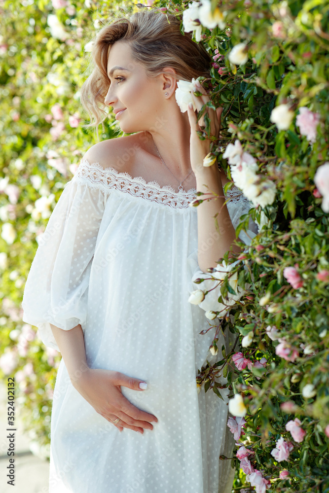 Beautiful pregnant women in nature. Pregnant girl with roses. Beautiful pregnant women in nature. Pregnant girl with roses.