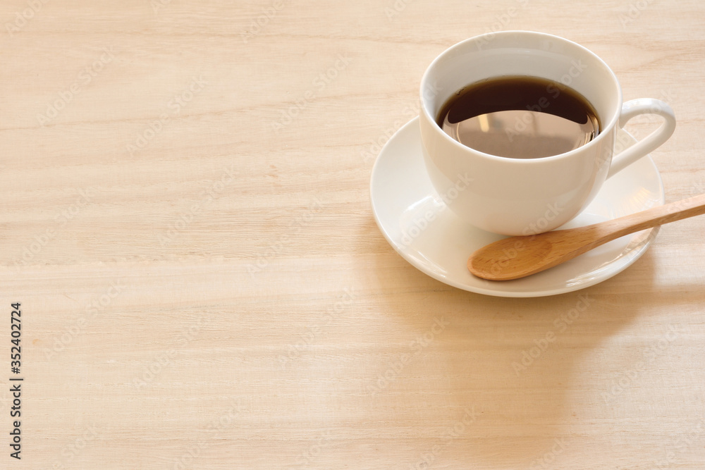 A cup of coffee on a wood table