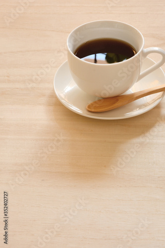 A cup of coffee on a wood table