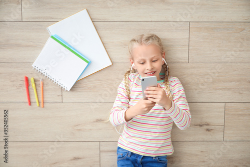 Cute little girl studying a...
