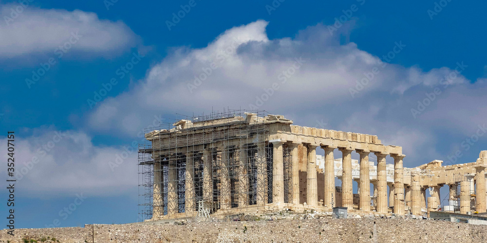 Parthenon on Acropolis of Athens under blue sky with some clouds, Greece