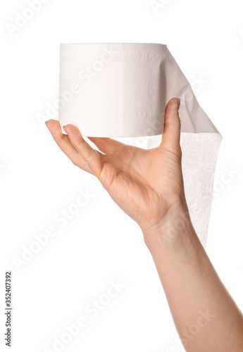 Hand with roll of toilet paper on white background