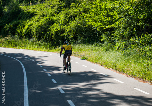 Fototapeta Naklejka Na Ścianę i Meble -  Cyclist riding bicycle on cycling trail path