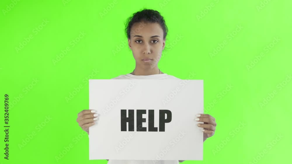 Afro-American Girl Activist With HELP Poster on chroma key background Afro-American Girl Activist With HELP Poster on chroma key background