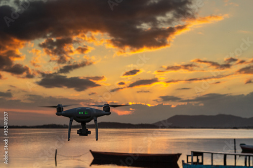 drone flying over the beach at sunset