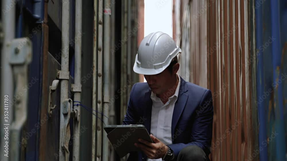 The engineer is inspecting the container in the warehouse.International shipping industry
The engineer is inspecting the container in the warehouse.International shipping industry