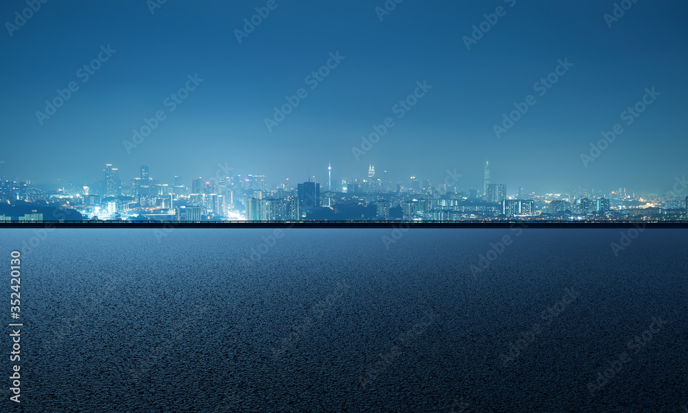 Empty asphalt road with city skyline background Empty asphalt road with city skyline background