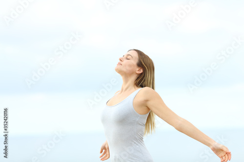Woman breathing fresh air at the beach