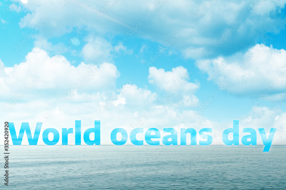Blue sea and sky with clouds, with the text world ocean day. Concept of world ocean day and conservation of the environment. Copy space