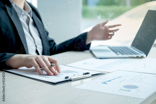 business man is sitting at a desk and calculating financial graph that show results