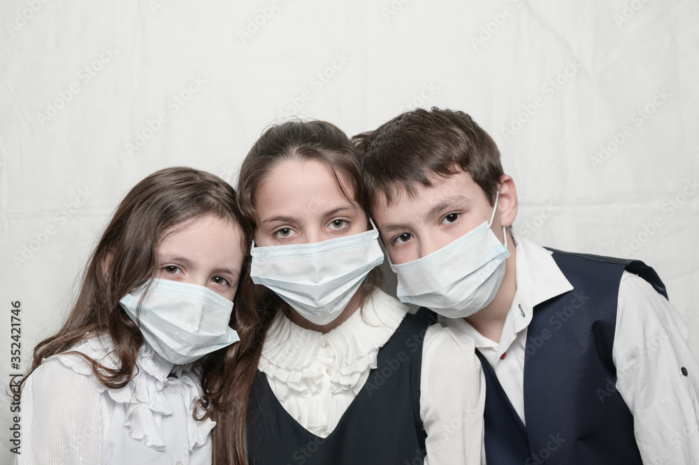 quarantine coronavirus covid-19 epidemic outbreak health care medicine concept of family children in school uniform wearing medical masks with copy space