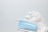 hygiene kit white medical gloves white blue mask on a grey background 