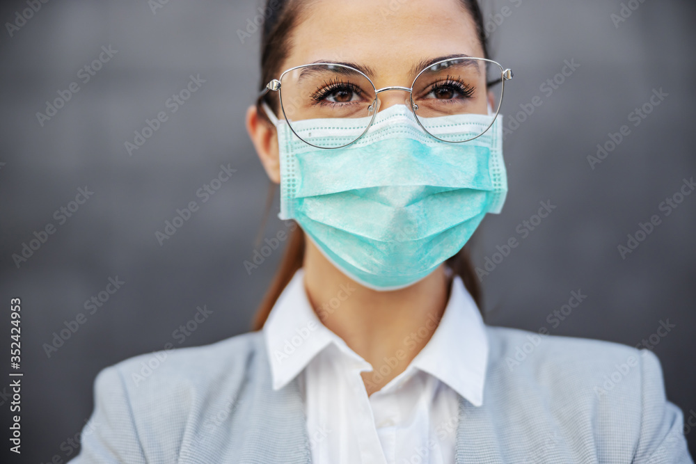 Portrait of gorgeous businesswoman with protection mask on standing outdoors. Protection form corona virus concept. Portrait of gorgeous businesswoman with protection mask on standing outdoors. Protection form corona virus concept.