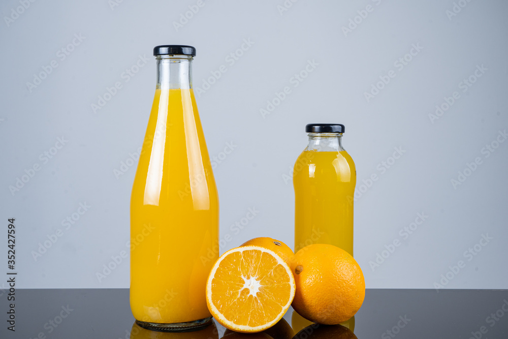 Bottle of orange juice and oranges Bottle of orange juice and oranges