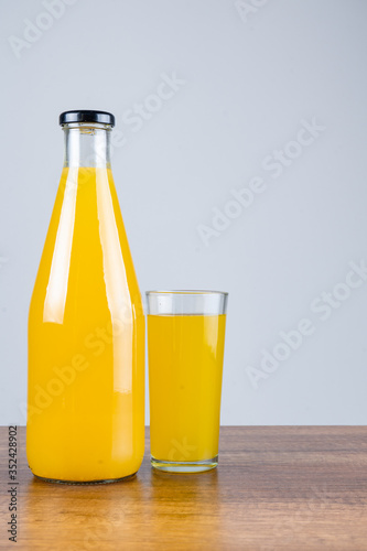 Bottle of orange juice and oranges
