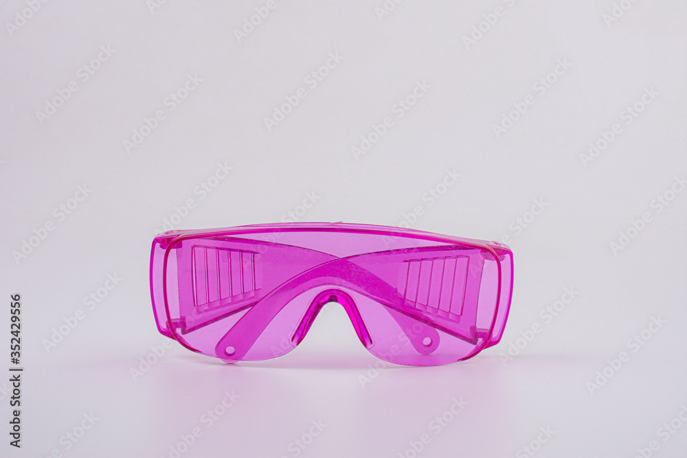 pink safety glasses isolated on white background. pink safety glasses isolated on white background.